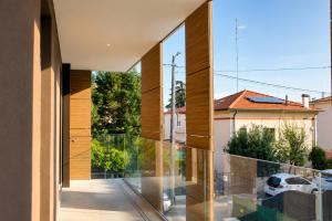 a view from the balcony of a house with glass walls at WELCOME residenza esclusiva via Liverani Imola in Imola