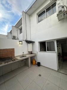 a kitchen with a sink and a building at Mini casita a in Rosario