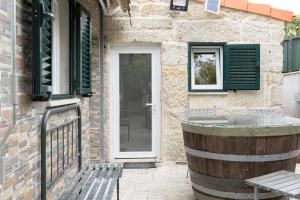 a door to a building with a barrel outside at Casa Fontenario in Vila Real