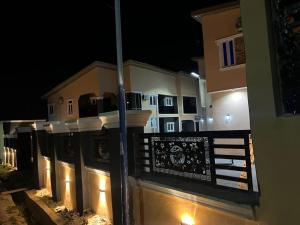 a view of a building at night with a fence at sky 7 hotel & apartment in Akure