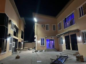 an empty courtyard of a building at night at sky 7 hotel & apartment in Akure