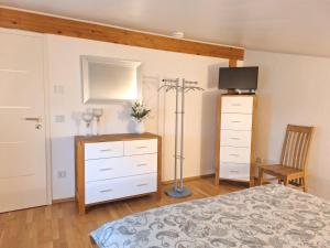 a bedroom with a bed and a dresser at modern und gemütlich in Linden