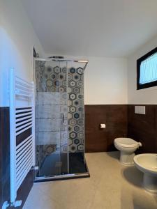 a bathroom with a shower and a toilet at Cav Casa Brunella in Castiglione della Pescaia +35 photos