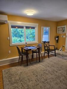 a living room with a table and chairs and a window at Cozy Sanctuary in Saltspring Island