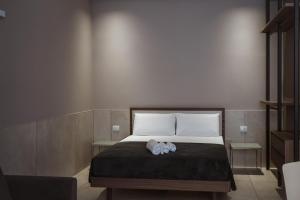 a bed with a stuffed animal on top of it at MEANDRI Apartment in San Severo