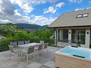 a patio with a table and chairs and a swimming pool at Murka Holiday Home in Bled