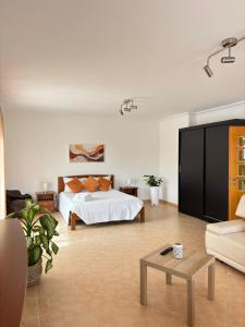 a bedroom with a bed and a living room at Vivenda Godinho in Nazaré