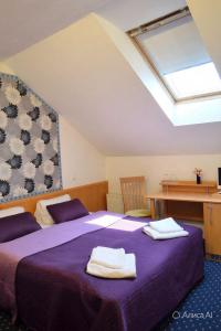 a bedroom with two beds with towels on them at Aladin Praha in Prague