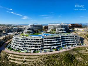 an aerial view of a building with a pool at Infinity View Apartments by NRAS in Arenales del Sol