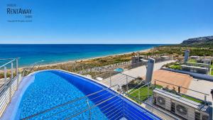 a view of the beach from the balcony of a house at Infinity View Apartments by NRAS in Arenales del Sol