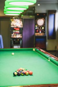 a pool table with balls on top of it at Hotel Harpf in Bressanone