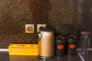 a coffee maker and two cups on a counter at Stellar Island Home-Kos in Kos