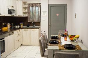 a kitchen with a table with a bowl of fruit on it at Stellar Island Home-Kos in Kos