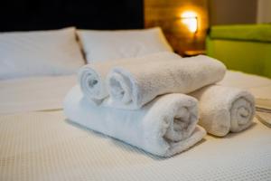 a pile of towels sitting on top of a bed at Stellar Island Home-Kos in Kos +53 photos