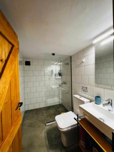 a bathroom with a toilet and a sink and a shower at Aloni Petit House in Nerotriviá +14 photos