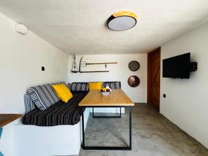 a living room with a couch and a table at Aloni Petit House in Nerotriviá