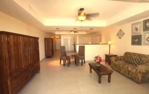 a living room with a couch and a table at The Crown House Hotel in Philipsburg +14 photos