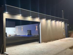 a building with an open door with lights on it at Lotus in Gurupi