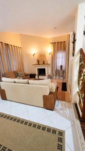 a living room with two couches and a fireplace at Di Fronte Al Bosco in Santa Teresa
