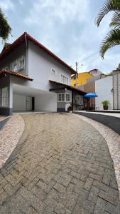 a house with a cobblestone driveway in front of it at Di Fronte Al Bosco in Santa Teresa