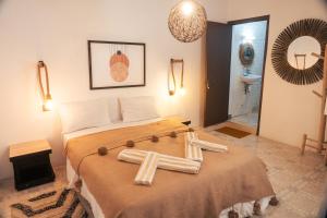 a bedroom with a bed with towels on it at Eco Bay Surf Camp in Aourir