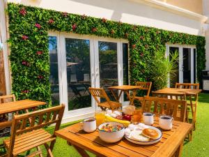 a wooden table with breakfast food on a patio at Ocean Beach Club in Fort Lauderdale
