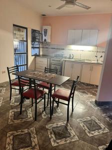 a kitchen with a table and chairs in a room at Fortunata Urban in San Miguel de Tucumán