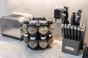 a group of glass bottles on a counter next to a toaster at North End Entire House in Boston +92 photos