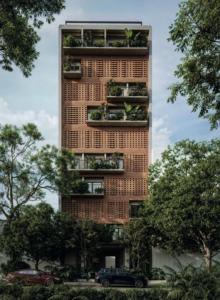 a tall building with balconies with plants on it at Obra Hotels in Medellín