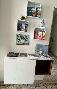 a white desk with pictures on a wall at Casa Grandi in Ca Tiepolo
