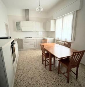 a kitchen with a wooden table and chairs in it at Casa Grandi in Ca Tiepolo