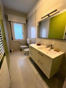 a bathroom with a white sink and a toilet at Casa Grandi in Ca Tiepolo