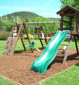 a playground with a slide and a climbing frame at Mittersill Alpine Resort in Franconia