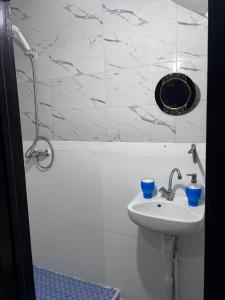 a white bathroom with a sink and a tub at Appartement Maroc Safi in Safi +13 photos