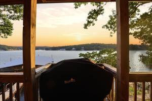 a screened in porch with a view of the water at Emerald waters in Camdenton