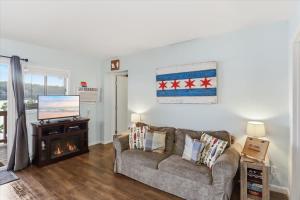a living room with a couch and a television at Emerald waters in Camdenton
