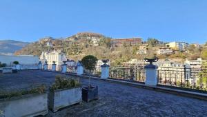a balcony with a fence with a view of a city at Le Cocon du Royat Palace in Royat
