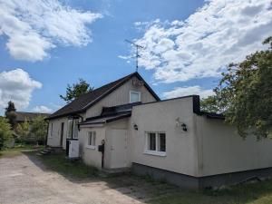 a white house with a antenna on top of it at A charming countryside accommodation near Malm in Oxie