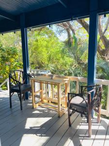a wooden table and two chairs on a porch at LOTO'S House in West End +25 photos