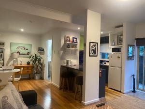 a kitchen and living room with a table and a counter at Beachfront Apartment in Melbourne +6 photos
