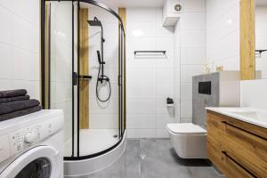a bathroom with a washing machine and a toilet at Świętego Mikołaja 14 Centrum in Głogów +26 photos