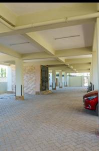 a parking garage with a car parked in it at Ryma Airbnbs in Mombasa +1 photo