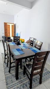 a dining room table with chairs in a room at Ryma Airbnbs in Mombasa