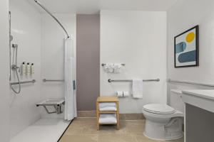 a bathroom with a shower and a toilet and a sink at City Express by Marriott St. Augustine in St. Augustine
