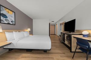 a hotel room with a bed and a desk at City Express by Marriott St. Augustine in St. Augustine