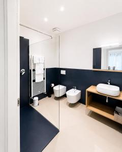 a bathroom with two toilets and a sink at Al Carlino Verona in Verona
