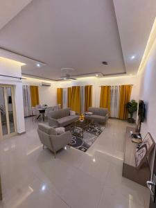 a large living room with couches and a table at La Kribienne in Cotonou