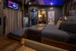 a bedroom with a swing bed in a room at "Squirrels Gone Wild" Luxury Treehouse Adventure Near Dollywood & Pigeon Forge in Sevierville
