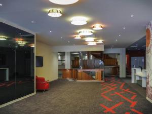 an office with a room with orange drawings on the ceiling at ibis Styles Poitiers Centre in Poitiers
