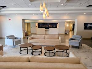 a lobby with couches and two tables and chairs at The Hotel Vue in Natchez